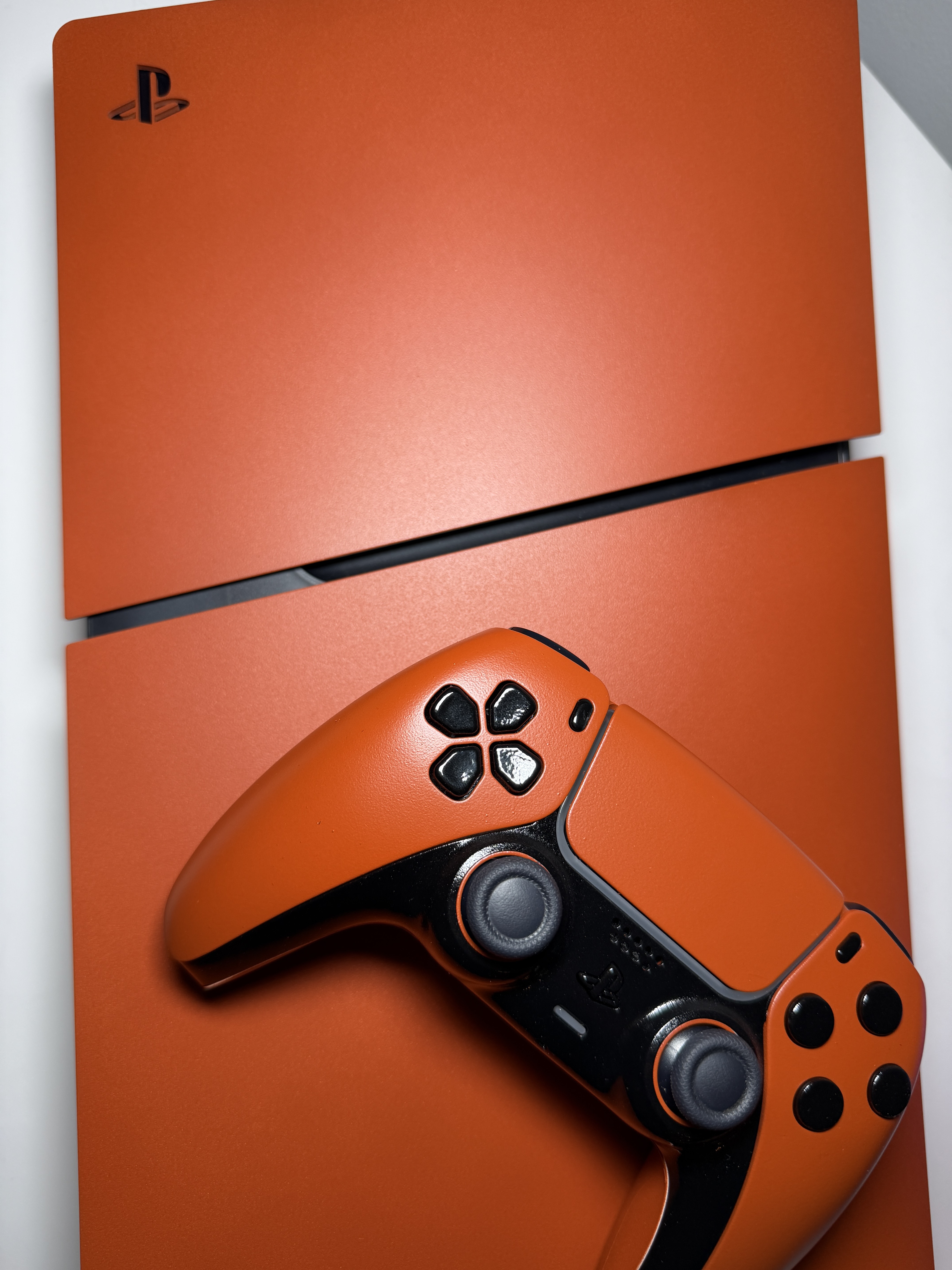 Custom orange PS5 console and controller — spray paint